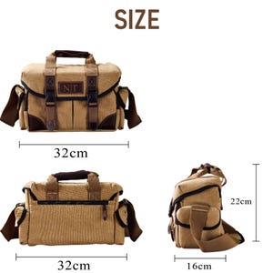 May include: A tan canvas camera bag with brown leather accents and adjustable straps. The bag measures 32 inches wide and 22 inches tall.