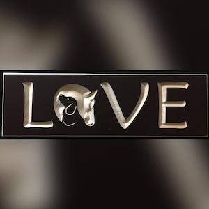 May include: A black wooden sign with the word "LOVE" carved in white. The "O" is replaced with a silhouette of a horse and dog's head.