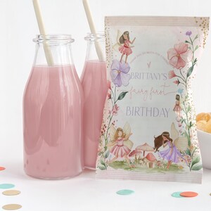 May include: A pink and white fairy-themed party favour bag with a floral design and the text "Brittany's fairy first birthday".