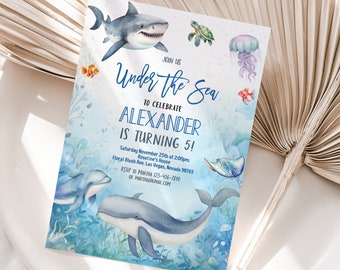 May include: Under the Sea themed birthday party invitation with a blue and white watercolor background. The invitation features a shark, a whale, a turtle, a jellyfish, and a dolphin. The text on the invitation reads "Join us Under the Sea to celebrate Alexander is turning 5!"  Saturday November 25th at 2:00pm. Floral Blush Ave, Las Vegas, Nevada 98765 Roseline's House RSVP to Marina 123-456-7890 or martha@gmail.com www.etsy.com/shop/iquickly