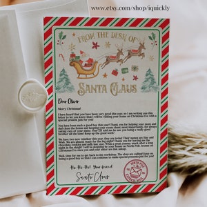 May include: A festive Christmas letter from Santa Claus, featuring a red and green striped border. The letterhead includes illustrations of Santa in his sleigh, reindeer, and Christmas trees. The text reads "From the Desk of Santa Claus" and is addressed to "Oliver".