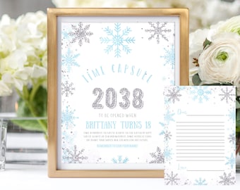 May include: A printable time capsule for a birthday party. The white card has a blue and silver snowflake design and the text "Time Capsule 2038 To Be Opened When Brittany Turns 18". The card has instructions to write a note about the birthday girl's dreams and aspirations for the future. A second card with lines for writing is included.