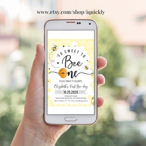 May include: A smartphone displaying a yellow and black bee-themed first birthday party invitation. The invitation reads "So Sweet to Bee One" and includes the date, time, and location of the party.