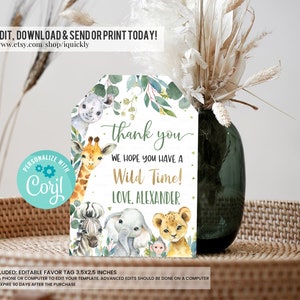 May include: Editable thank you tag with a jungle theme. The tag features a giraffe, zebra, elephant, lion, and monkey with green foliage. The text reads "thank you, we hope you have a wild time! Love, Alexander". The tag is 3.5 by 2.5 inches.