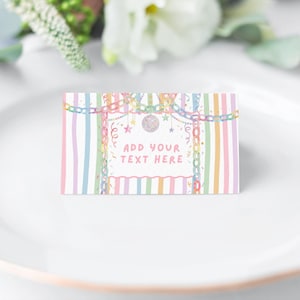 May include: A rectangular place card featuring a pastel striped border in pink, blue, yellow, and green. The center displays a white area with the text ADD YOUR TEXT HERE, decorated with illustrations of colorful chains, stars, and a disco ball.