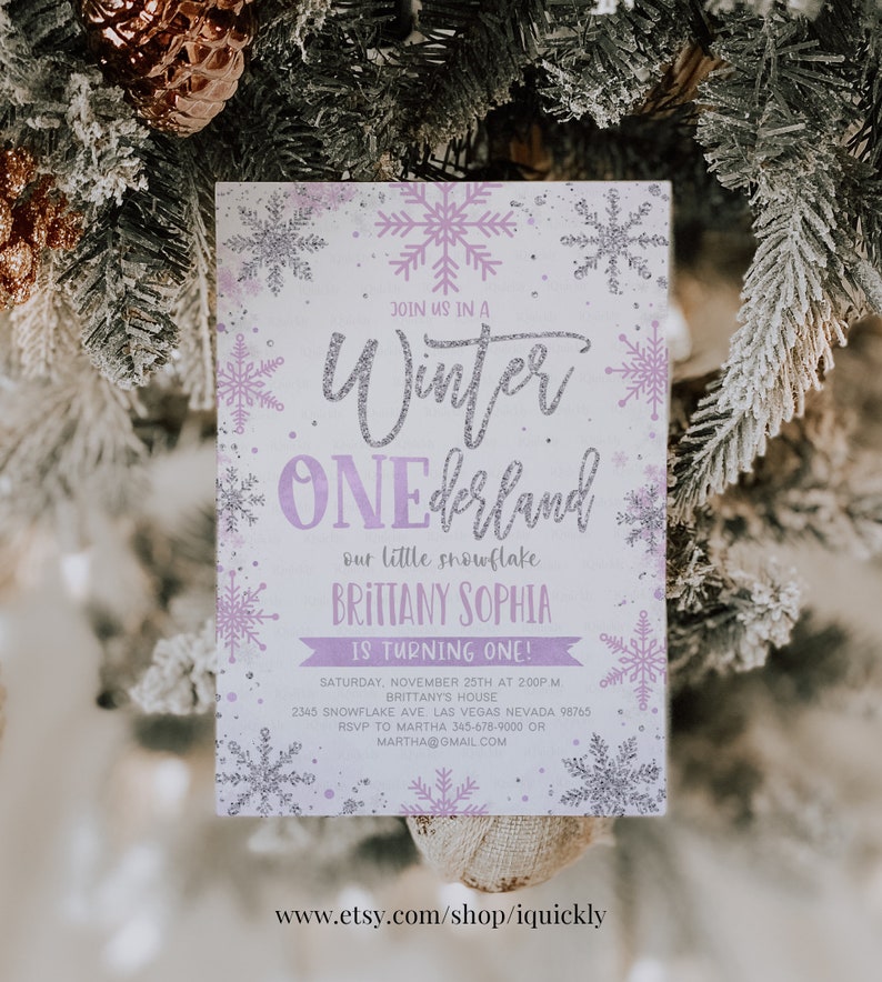 May include: A winter-themed invitation with a snowflake design. The invitation features the text "Winter ONEderland" in silver glitter, with the name "Brittany Sophia" and event details in purple. The background is white with purple and silver snowflakes.