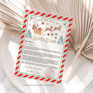 May include: A festive letter from Santa Claus, featuring a red and green border. The letterhead includes illustrations of Santa's sleigh, reindeer, and Christmas trees. The text reads "From the Desk of Santa Claus" and is addressed to "Dear Oliver."