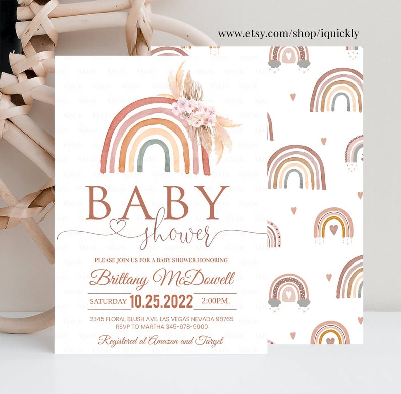 May include: A baby shower invitation with a watercolor rainbow design in shades of pink, orange, and brown. The invitation features the text "BABY shower" and includes the date, time, and location of the event. The text "Registered at Amazon and Target" is also included.