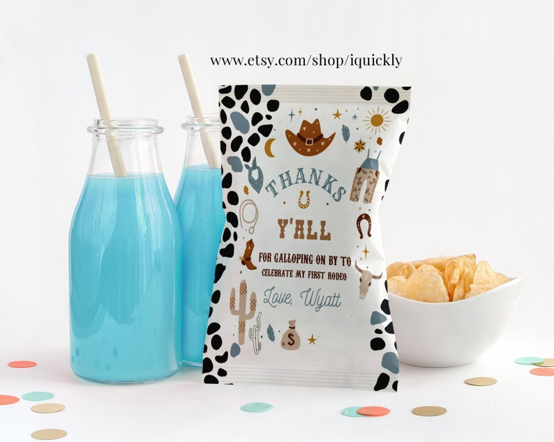 May include: A white chip bag with a black and white cow print pattern. The bag has a thank you message with a cowboy theme and the text "Thanks Y'all for galloping on by to celebrate my first rodeo. Love, Wyatt".