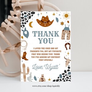 May include: A white thank you card with a cowboy theme. The card features a brown cowboy hat, a blue bandana, a pair of brown overalls, a cactus, a horseshoe, a skull, and a money bag. The text on the card reads "Thank You" and "I loved the cake and my presents too, but my favorite part was seeing you! Thank you for making my birthday very special! Love, Wyatt'"