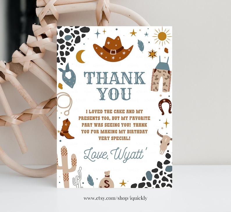 May include: A white thank you card with a cowboy theme. The card features a brown cowboy hat, a blue bandana, a pair of brown overalls, a cactus, a horseshoe, a skull, and a money bag. The text on the card reads "Thank You" and "I loved the cake and my presents too, but my favorite part was seeing you! Thank you for making my birthday very special! Love, Wyatt'"