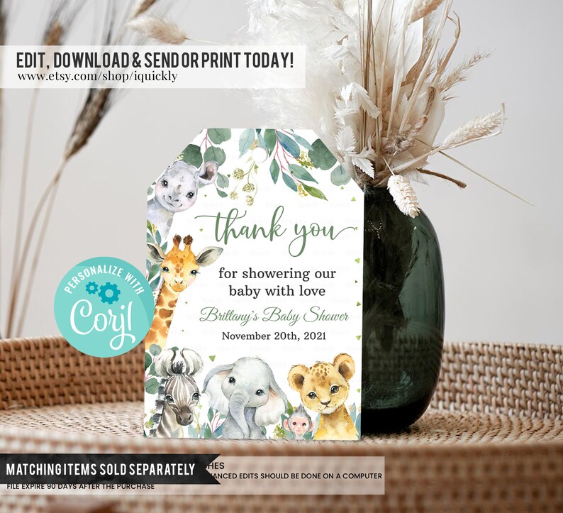 May include: Thank you tag with a watercolor illustration of a giraffe, zebra, elephant, lion, and monkey. The tag is green and white with gold glitter. The text on the tag reads "Thank you for showering our baby with love. Brittany's Baby Shower November 20th, 2021".