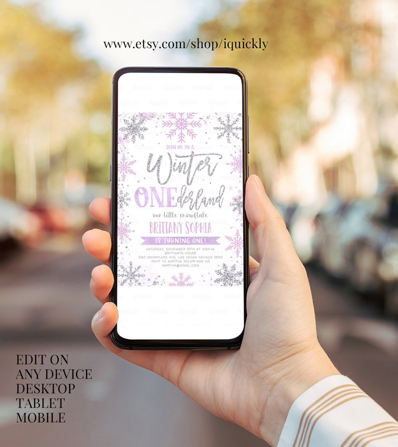 May include: A smartphone displaying a winter-themed invitation. The invitation features the text "Winter ONEderland" with snowflake and glitter accents. The invitation includes event details and the text "Edit on any device desktop tablet mobile."