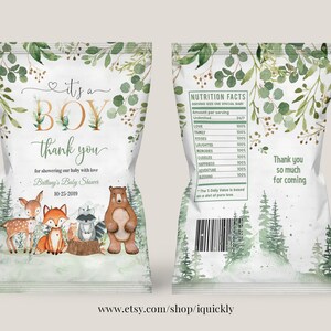 May include: A baby shower favour bag with a woodland theme. The bag is white with green foliage and a gold 'It's a Boy' design. The front of the bag features a deer, fox, raccoon, and bear. The back of the bag has a nutrition facts label with a humorous list of baby shower essentials. The bag also includes the text 'Thank you so much for coming'.