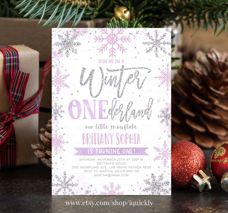 May include: A Winter ONEderland invitation with a snowflake theme. The invitation features the text "Winter ONEderland" in silver glitter, with the name "BRITTANY SOPHIA" and the words "IS TURNING ONE!" in purple. The invitation also includes event details.