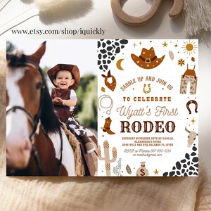 May include: A white invitation with brown and gold accents for a child's first rodeo. The invitation features a cowboy hat, boots, a horseshoe, and a cactus. The text on the invitation reads "Saddle Up and Join Us to Celebrate Wyatt's First Rodeo".