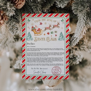 May include: A festive Christmas letter from Santa Claus, featuring a red and green border with candy cane stripes. The letterhead reads "From the Desk of Santa Claus" with a sleigh and reindeer illustration. The letter is addressed to "Oliver".