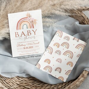 May include: A baby shower invitation with a rainbow design. The invitation is for Brittany McDowell and is scheduled for Saturday, October 25, 2022 at 2:00 PM. The invitation includes the address and RSVP information. The invitation also includes the text "Registered at Amazon and Target" and a website address.