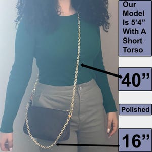 May include: A gold chain strap bag with a black fabric body. The strap is 40 inches long and the bag is 16 inches wide. Our model is 5'4" with a short torso.