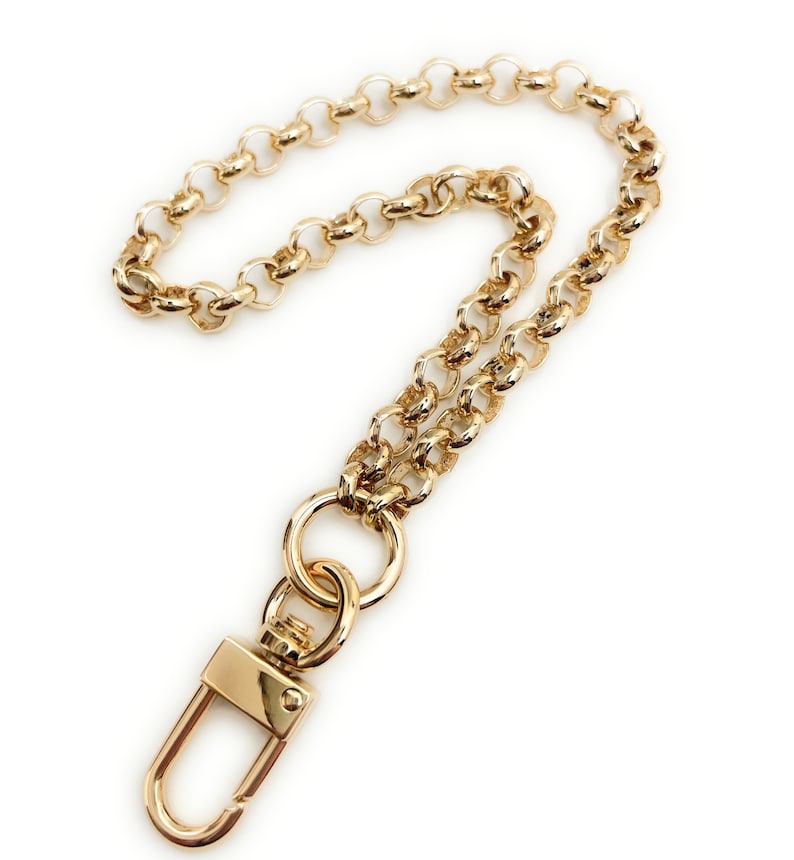May include: A gold chain with a lobster clasp. The chain is made of small, round links.