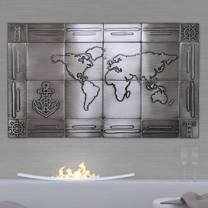 May include: A metal wall art piece featuring a world map design, an anchor, and nautical elements. The artwork is mounted above a white fireplace with a flame effect. The room includes a white bench, pillows, and a blanket.