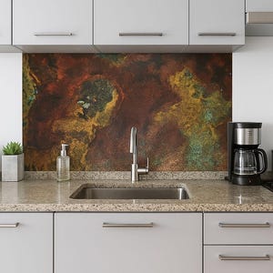 May include: Kitchen interior with a stainless steel sink, tap, and coffee maker. The backsplash has a textured, abstract design in shades of brown, gold, and green. Two small potted plants sit on the countertop.