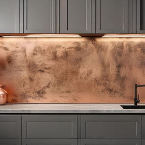 May include: A modern kitchen design featuring dark gray cabinets, a copper backsplash, and a black faucet. Two copper vases and a decorative plant are on the countertop. Overhead cabinets are also dark gray.