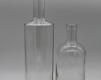 Enchanting ensemble of heavy glass vases made from vintage whiskey bottles