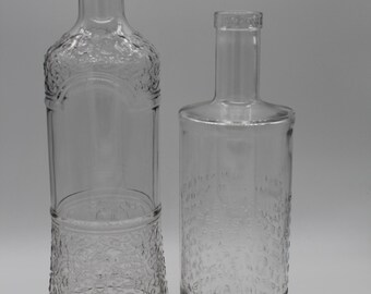 Enchanting ensemble of heavy glass vases made from vintage gin and vodka bottles with inlaid letters and elaborate decorations