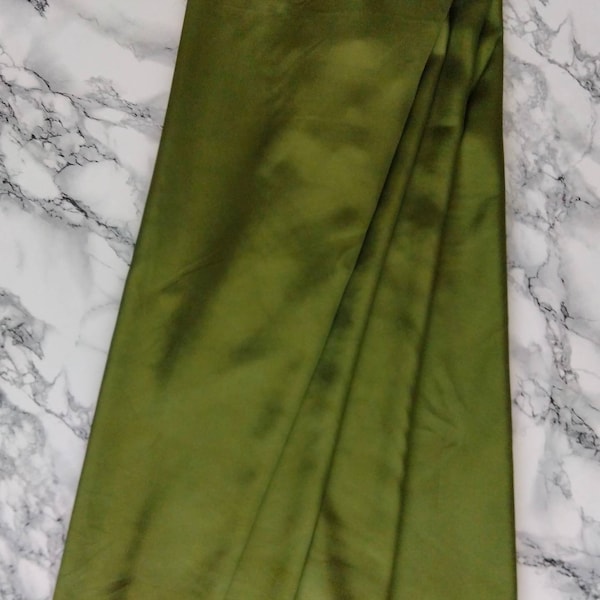 Viscose fabric green color. Sewing fabric. Making clothing fabric by the meter