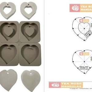 May include: A set of four heart-shaped silicone molds for making resin ornaments. The molds are shown next to two finished resin ornaments and a template for making the ornaments. The template includes instructions for making the ornaments. The text on the template reads "Tea Rose Mandalas Ornament Set Featuring Heart".