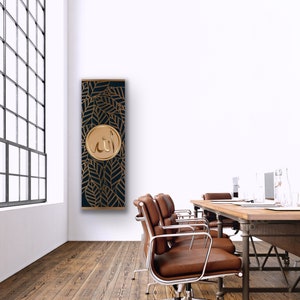 May include: A black and gold wall art print with a decorative pattern of leaves and the word "Allah" in a gold circle.