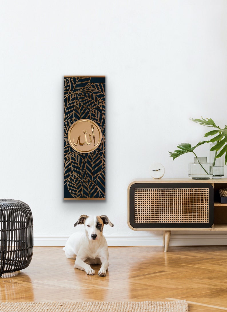 May include: A vertical wall art piece with a dark blue background and gold leaf design. The center of the art piece features a gold circle with the Arabic word "Allah" written in gold.