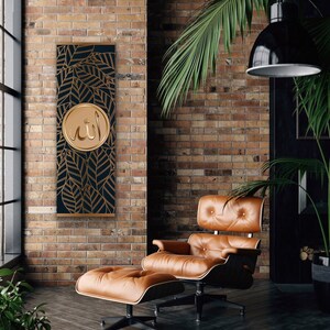 May include: A gold and black wall hanging with a circular design featuring the Arabic word "Allah" in gold lettering. The design is surrounded by a pattern of gold leaves on a black background.
