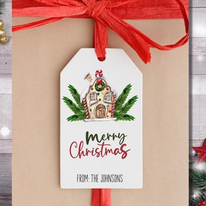 May include: White gift tag with a gingerbread house illustration and the text "Merry Christmas" and "From: The Johnsons". The tag is tied with a red ribbon.