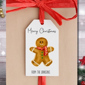 May include: White gift tag with a gingerbread man illustration and the text "Merry Christmas" and "From: The Johnsons".
