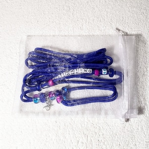 May include: A blue and purple beaded necklace with a silver clasp and the word "FIGHTING" spelled out in white letter beads. The necklace is in a clear plastic bag.