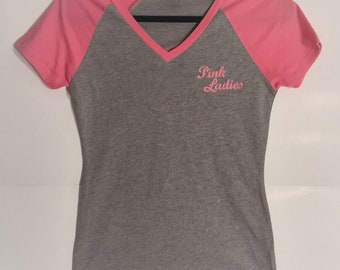Pink Ladies V-Neck Junior Sizes. In Stock (1) MD 30&quot; Bust, (2) LG 32&quot; Bust. Same Day Shipping.