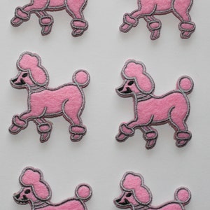 May include: Six pink felt poodle patches with silver trim. The poodles are in a walking pose with their tails curled up.