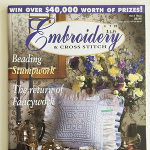 May include: A magazine cover for Embroidery & Cross Stitch magazine, volume 4, number 1. The cover features a white cushion with blue embroidery, a silver tea set, and a bouquet of flowers. The text on the cover reads "Win over £40,000 worth of prizes!" and "The return of Fancywork".