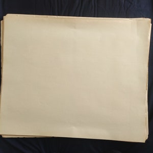 May include: A stack of blank, off-white paper sheets.