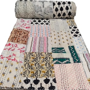 May include: A patchwork quilt with a variety of floral and geometric patterns in shades of brown, pink, green, and white. The quilt is made of cotton and is hand-stitched.