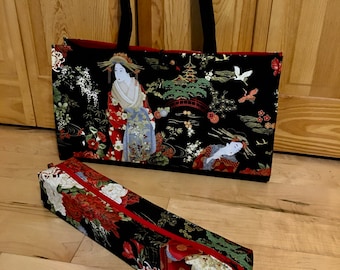 May include: Black tote bag and pencil case featuring a Japanese geisha design. The tote bag has black handles and a red interior. The pencil case has a red zipper. Both items display a colorful print with geishas, flowers, and pagodas.