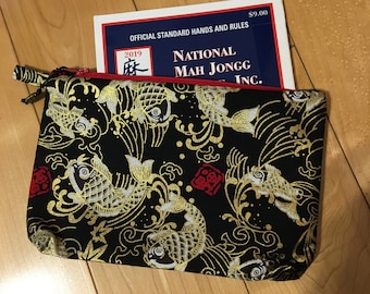 May include: Black zippered pouch with a gold koi fish pattern and a red zipper. The pouch contains a booklet titled "Official Standard Hands and Rules" for National Mah Jongg Inc.