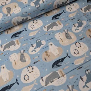 May include: Pale blue fabric featuring a repeating pattern of arctic animals such as seals, polar bears, penguins, whales, and fish. The design includes small islands with trees and wavy lines, creating a whimsical, nautical theme.