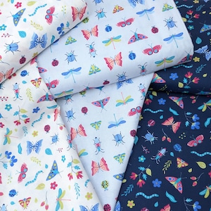 May include: Three fabric swatches featuring a repeating pattern of butterflies, dragonflies, ladybugs and beetles on a white, light blue and dark blue background.