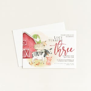 The image is a birthday invitation for a girl named Lucy, who is turning three. The invitation features illustrations of farm animals and a red barn, along with the text "Please join us to celebrate Lucy turning three".