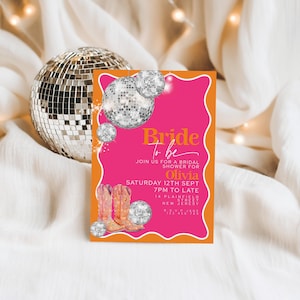 May include: A bridal shower invitation with a pink and orange design. The invitation features the text "Bride to be" and details for Olivia's shower, including the date, time, and location. Decorative disco balls and cowboy boots are also included.