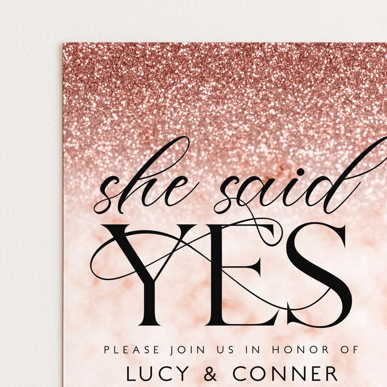 The image is a wedding invitation with a pink glittery background and the text "she said yes" prominently displayed.