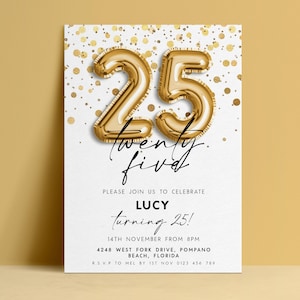 May include: A white invitation card with gold confetti and gold foil balloon numbers that read "25". The text "twenty five" is written in cursive below the numbers. The invitation reads "Please join us to celebrate Lucy turning 25!"